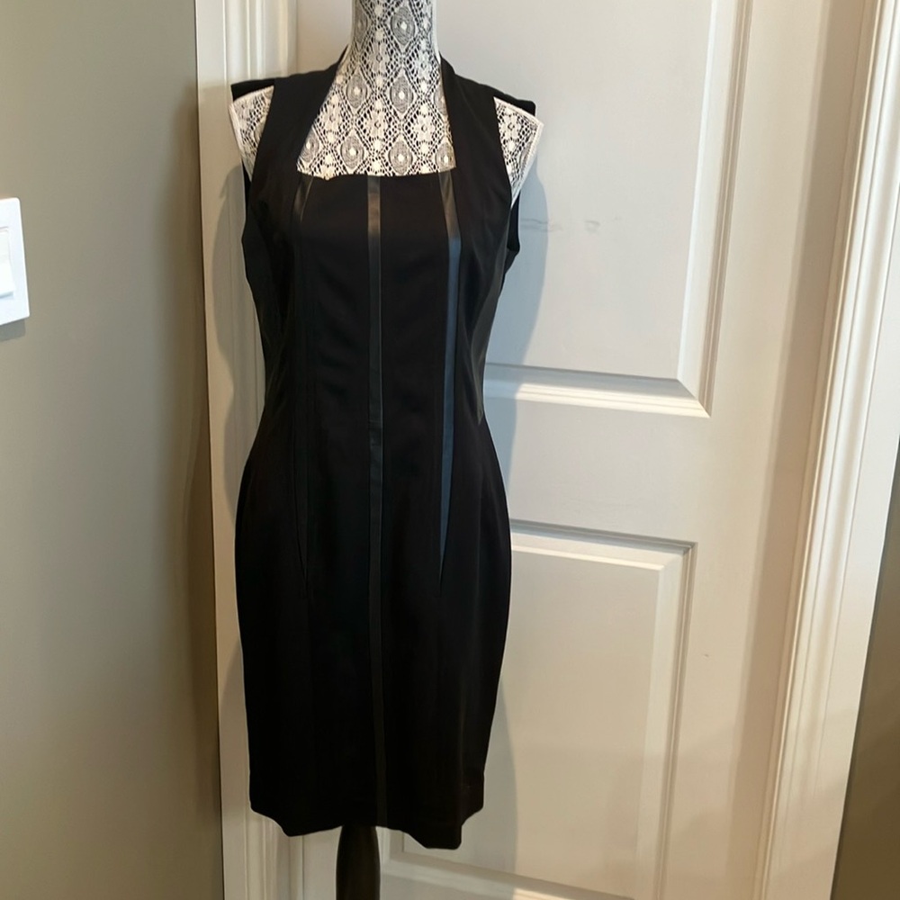Classic sleeveless LBD with fabulous faux leather detail  in lines down dress.